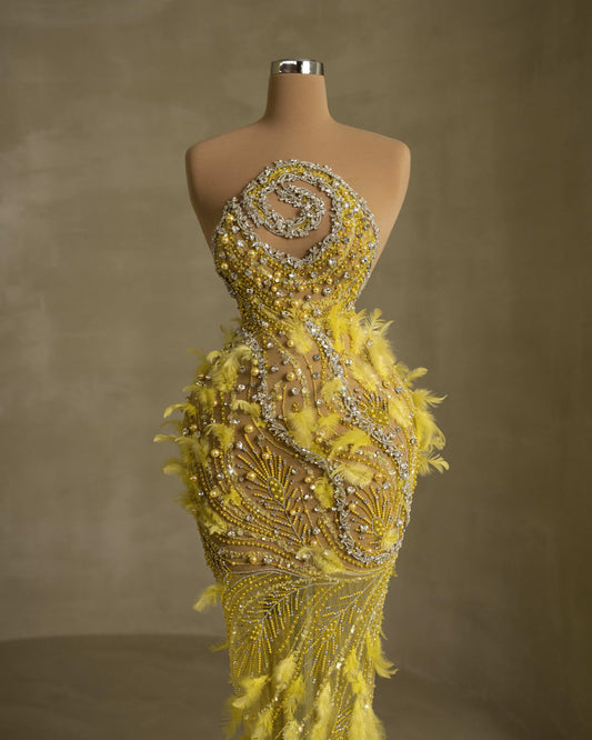 Sleeveless dress featuring exquisite feather embellishments and stoned detailing