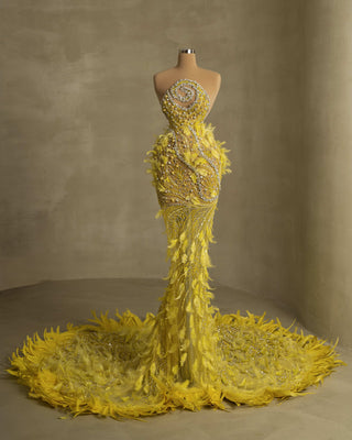 Elegant sleeveless gown adorned with feather accents and gemstones