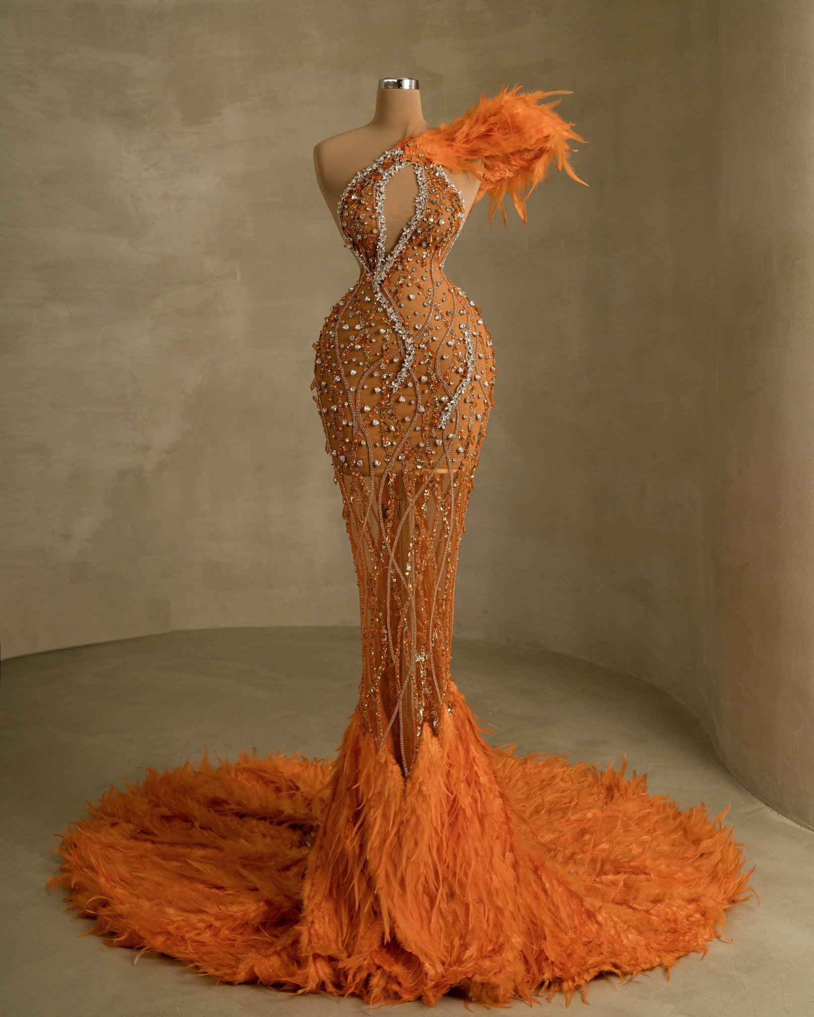 Exquisite dress adorned with sparkling gemstones and elegant feather accents