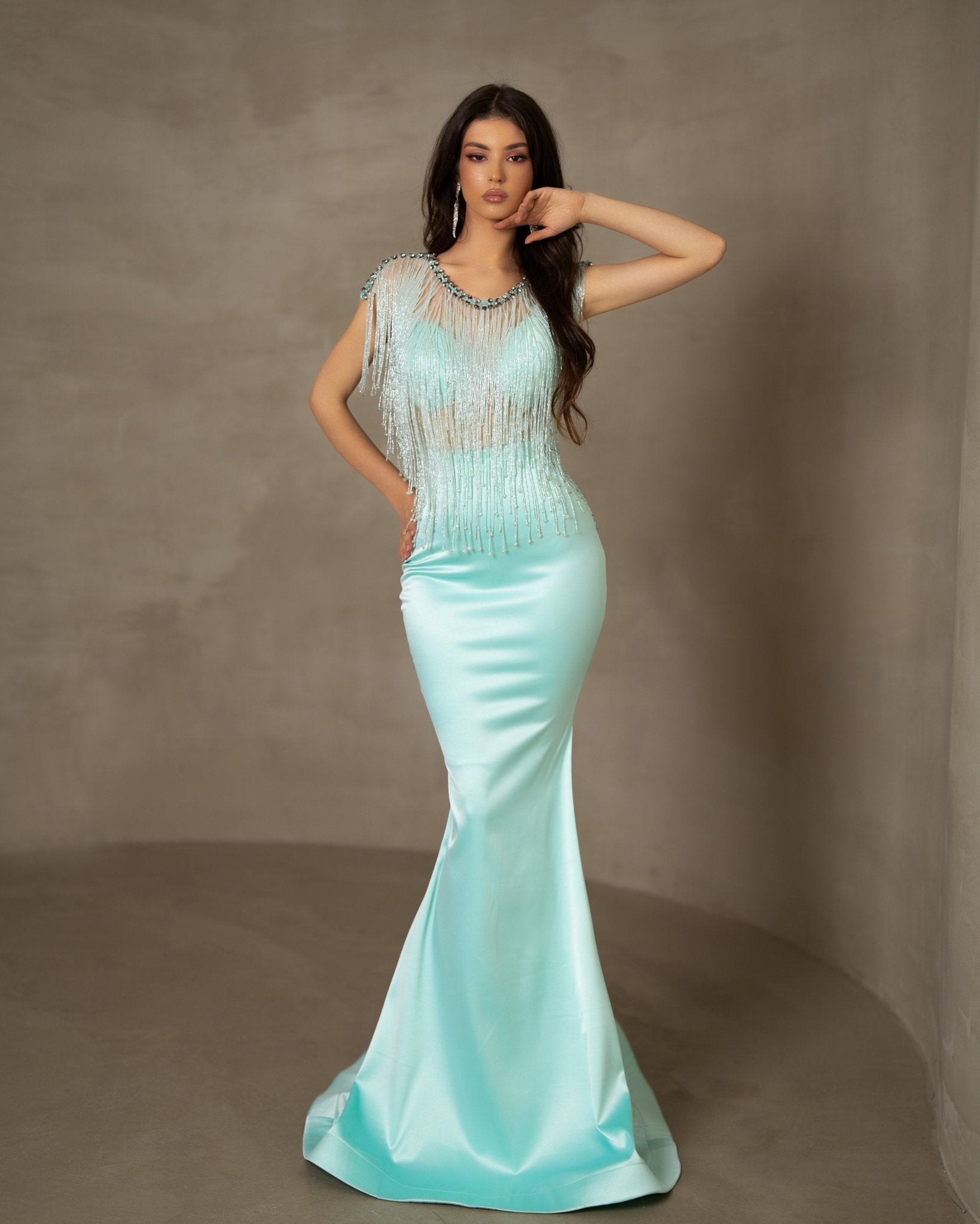 Mint-colored dress featuring a delicate interplay of texture with embellished tassels.
