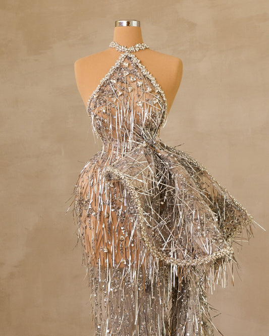 A graceful sleeveless dress with an enchanting side tail, perfect for any occasion.