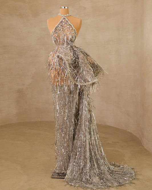 Elevate your style with this sleeveless Lisia dress featuring an elegant side tail design.