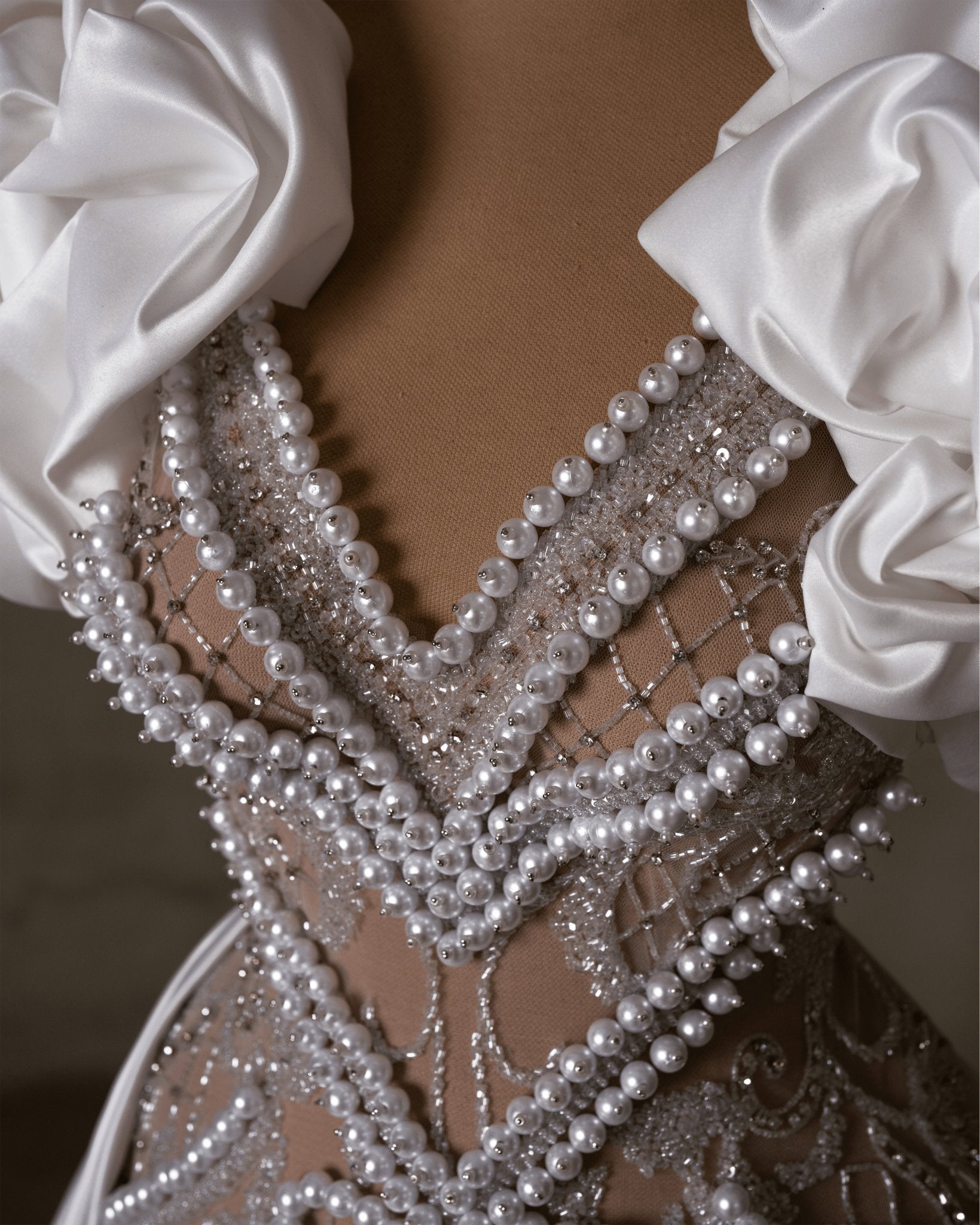 Pearl-studded lace bridal dress with satin shoulders