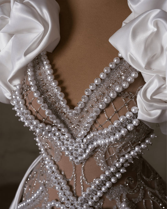 Pearl-studded lace bridal dress with satin shoulders