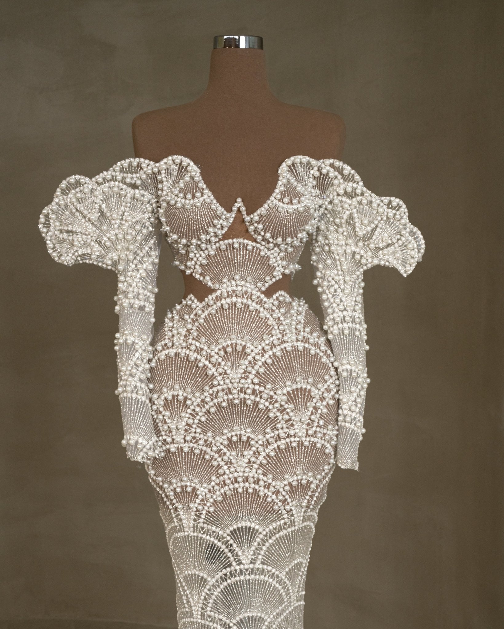 Off-shoulder bridal dress with intricate pearl embellishments