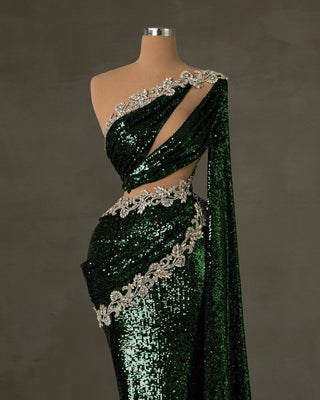 Show-stopping green sequin dress with daring cutouts and side cape