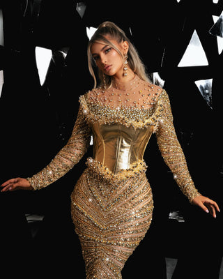 Elegant long-sleeved gold gown with metallic leather corset detail