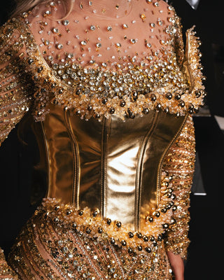 Close-up of intricate gold sequin lace detail