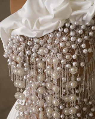 Lace and pearls unite in this chic bridal dress.