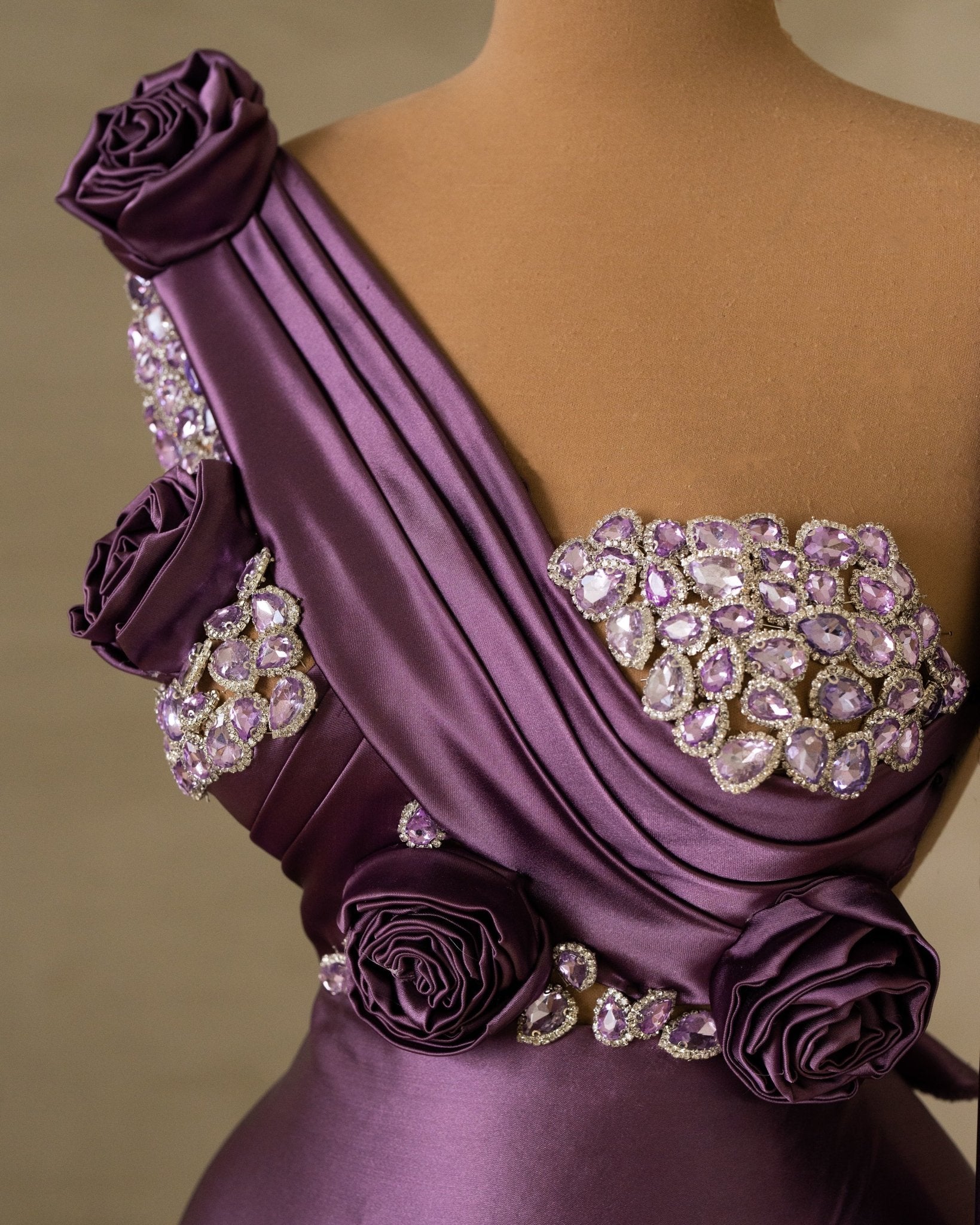 Close-Up of Purple Satin Dress Embellished with Stones and Flowers
