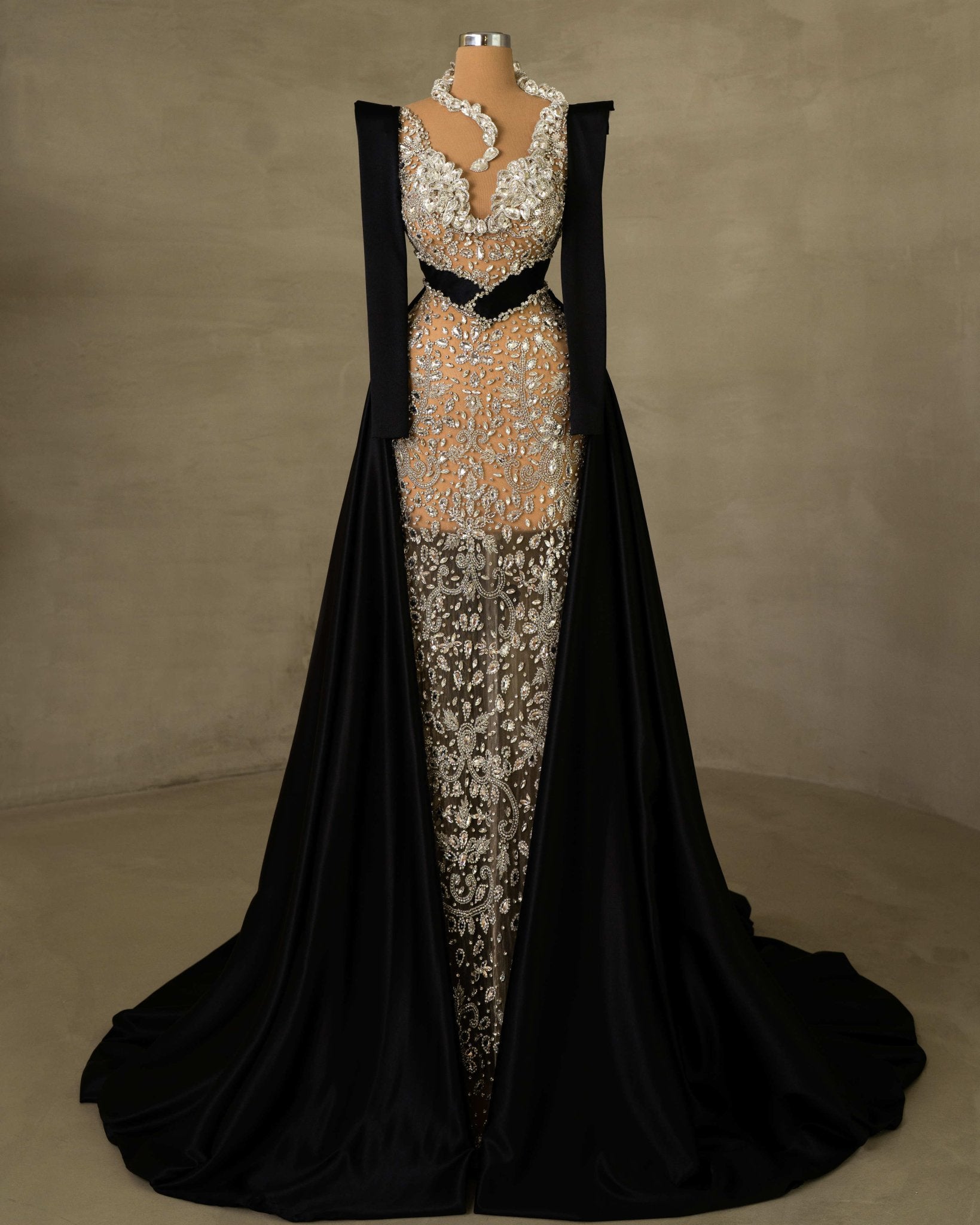 Elegant Dress Adorned with Stones and Featuring a Chic Overskirt