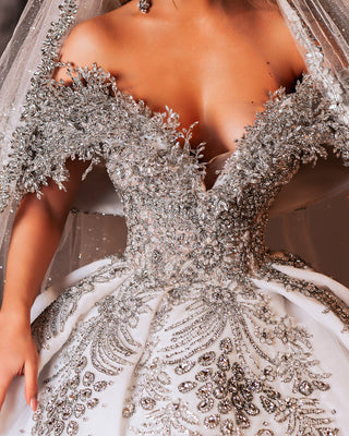 Close-up of intricate crystal detailing on wedding gown.
