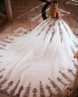 Stunning wedding dress with crystal-accented train and veil ensemble