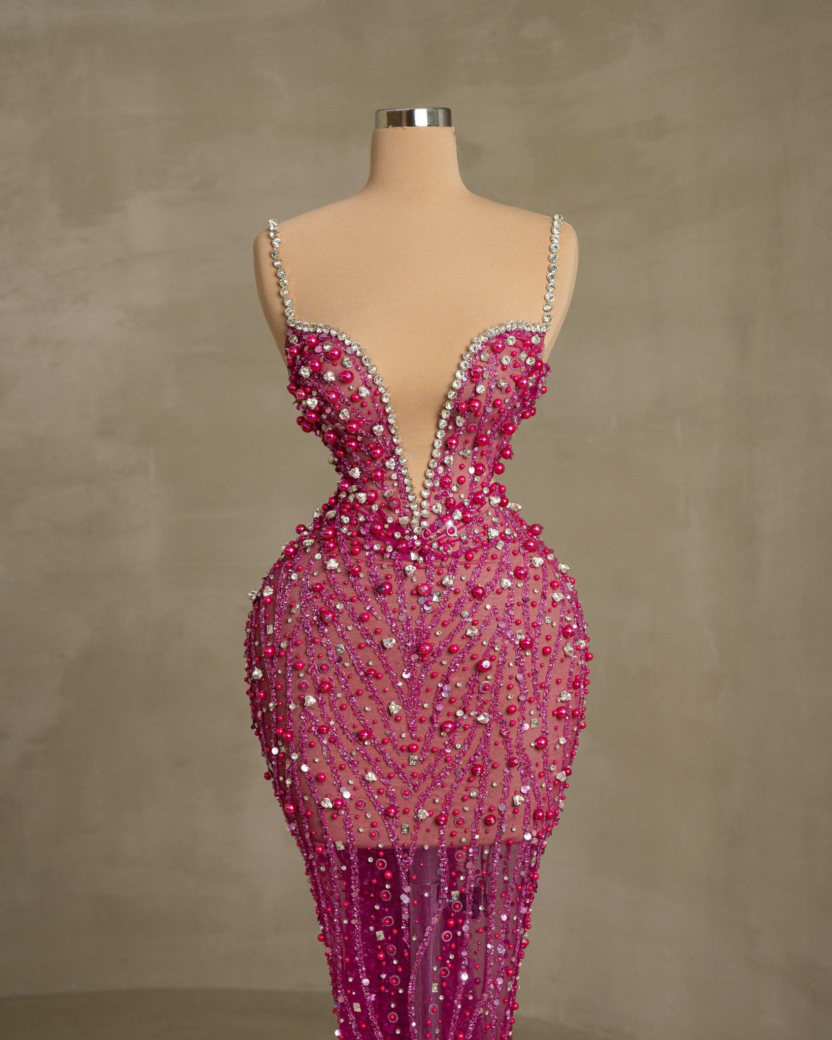 Fashionable Open Chest Dress with Intricate Stone and Feather Details