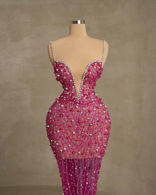 Fashionable Open Chest Dress with Intricate Stone and Feather Details