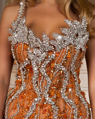Thin straps and crystal-adorned bodice of the dress.