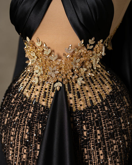 Close-up of Black Dress with Intricate Gold Stone Embellishments - Luxurious Detailing