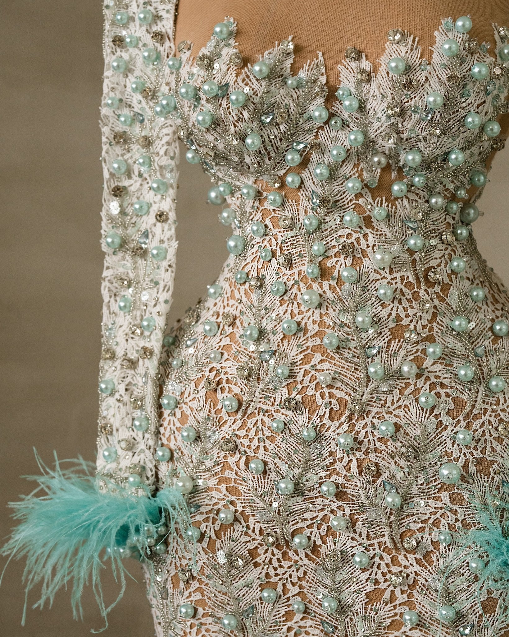 Intricate Bead and Feather Accents on Blue Gown