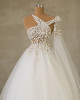 Elegant Bridal Gown Featuring Side Cape and Crystal Adornments