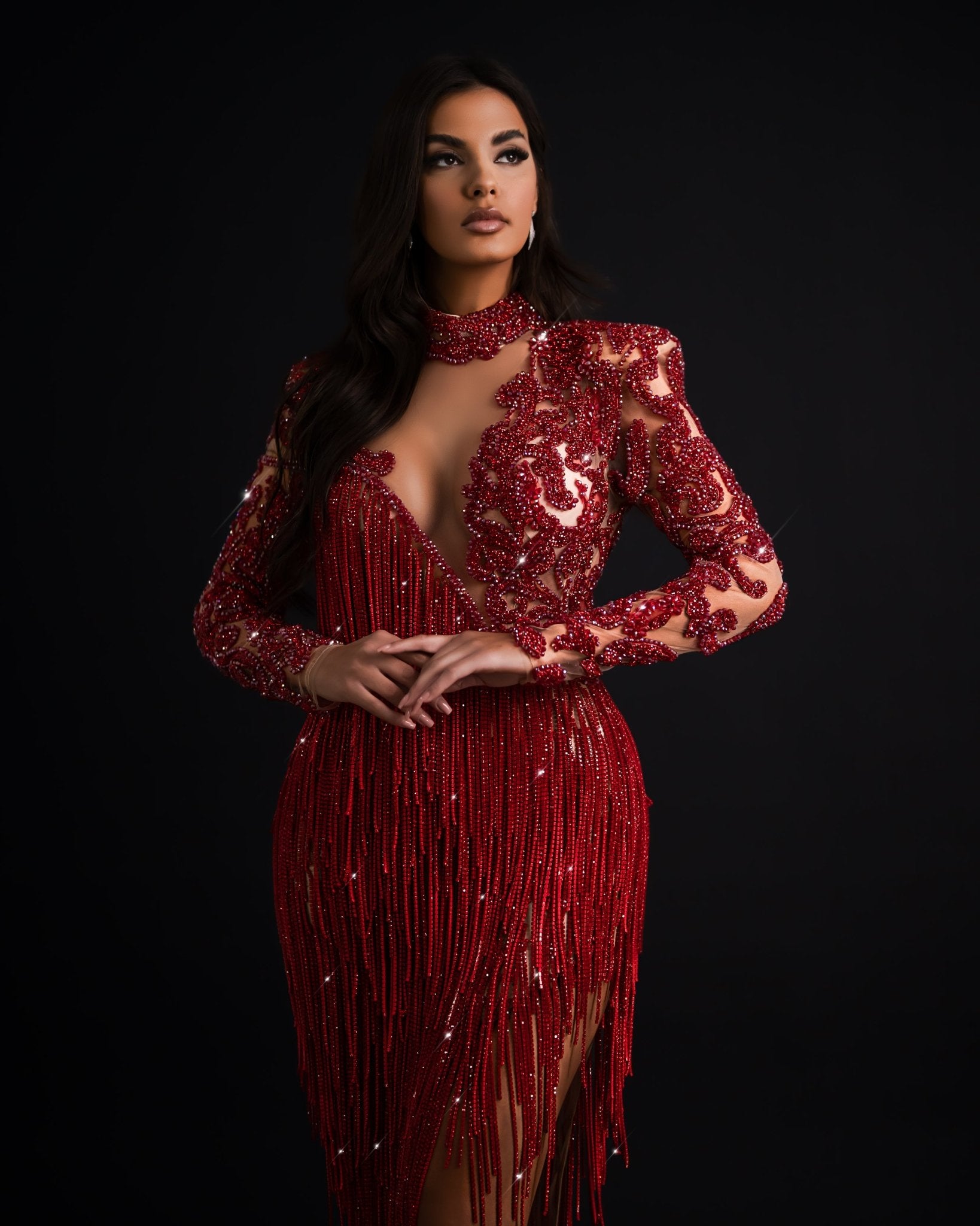 Red tassel dress with high neck, deep slit, and cut-out design.